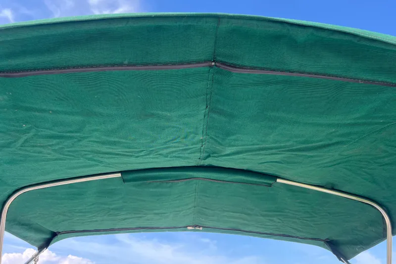 Slide: The Image of Green canopy of 2007 Azure AZ240 boat against blue sky. - 58