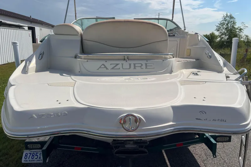 Slide: The Image of 2007 Azure AZ240 boat rear view, parked outdoors with visible license plate. - 6