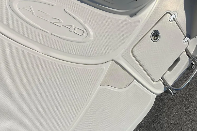 Slide: The Image of 2007 Azure AZ240 boat deck with storage compartment and textured surface. - 60
