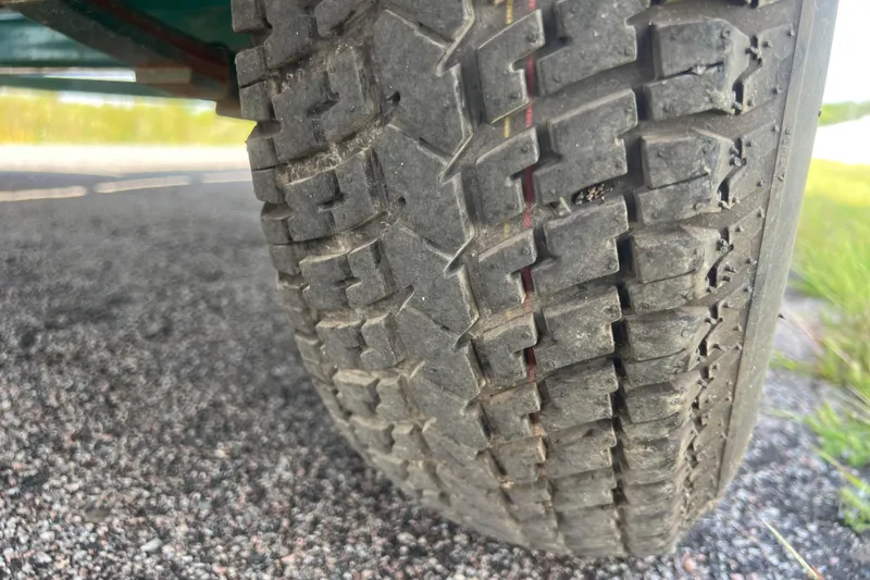 Slide: The Image of Close-up of a 2007 Azure AZ240 tire on a gravel road. - 62