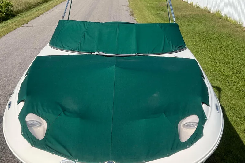 Slide: The Image of Covered Azure AZ240 boat on a road, green canvas, 2007 model. - 8