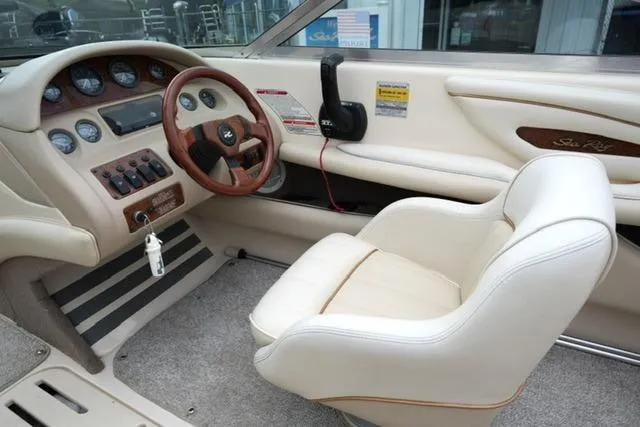 Slide: The Image of Interior of a 1995 Sea Ray 200 Select boat, featuring a classic dashboard and steering wheel. - 12