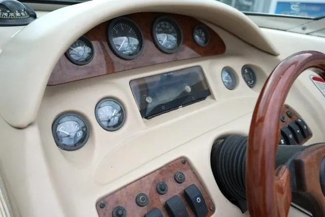 Slide: The Image of Dashboard of a 1995 Sea Ray 200 Select boat with gauges and controls. - 14