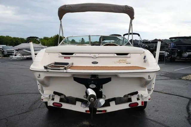 Slide: The Image of 1995 Sea Ray 200 Select boat, rear view, parked on asphalt with canopy. - 5
