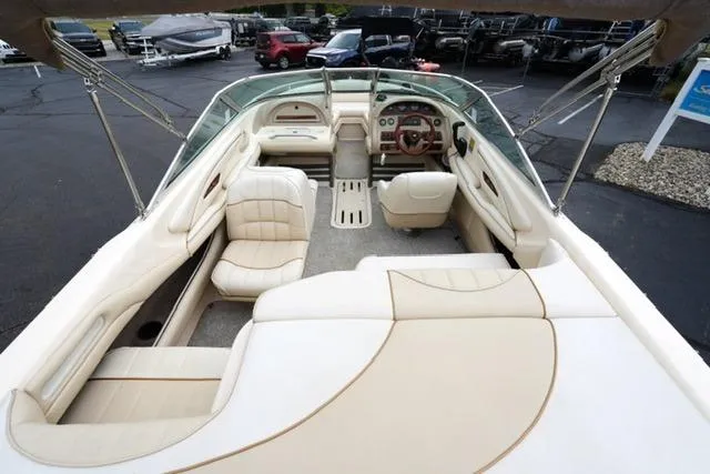 Slide: The Image of 1995 Sea Ray 200 Select boat interior with beige seating and dashboard. - 7