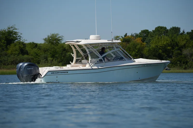 Slide: The Image of 2023 Grady-White Freedom 285 boat cruising on a serene lake. - 20