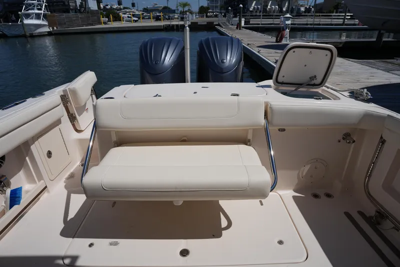 Slide: The Image of 2023 Grady-White Freedom 285 boat interior with seating and dual outboard motors. - 24