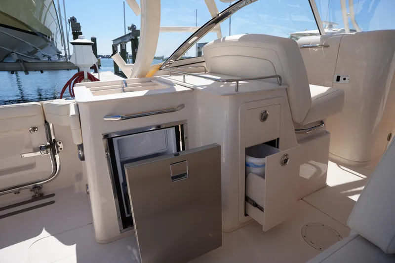 Slide: The Image of 2023 Grady-White Freedom 285 boat interior with open storage compartments and seating. - 27