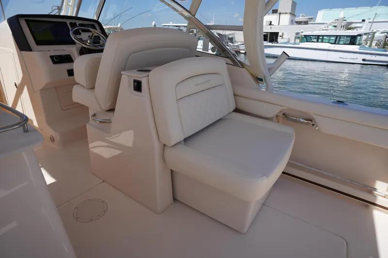 Slide: The Image of 2023 Grady-White Freedom 285 boat interior with luxurious seating and helm. - 29