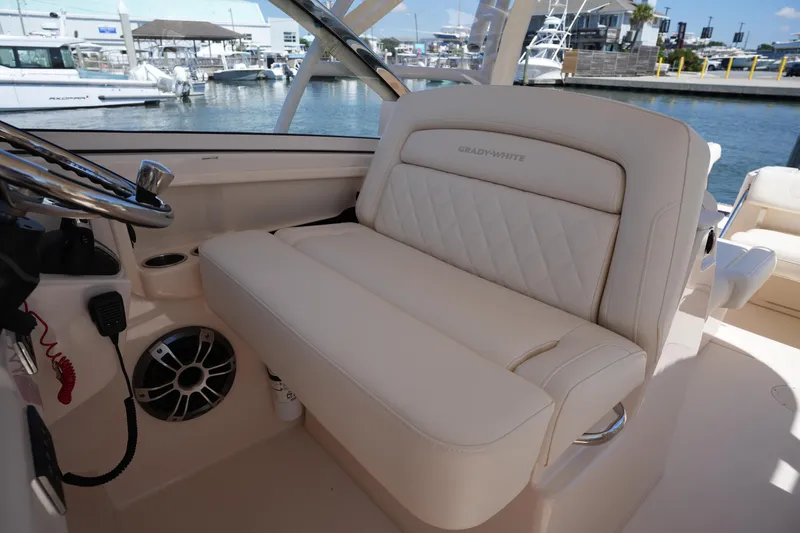 Slide: The Image of 2023 Grady-White Freedom 285 boat interior with luxurious seating and steering wheel. - 34