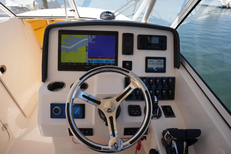 Slide: The Image of Helm of 2023 Grady-White Freedom 285 boat with navigation and control systems. - 35