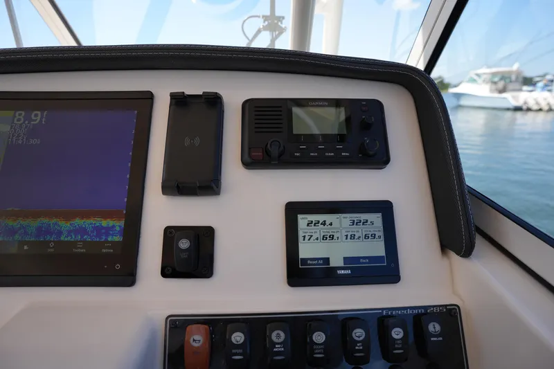 Slide: The Image of 2023 Grady-White Freedom 285 dashboard with navigation and control displays. - 37