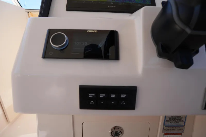 Slide: The Image of 2023 Grady-White Freedom 285 boat dashboard with Fusion audio system and controls. - 41