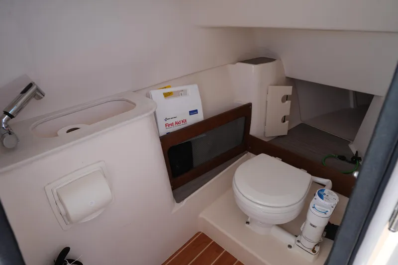 Slide: The Image of 2023 Grady-White Freedom 285 boat interior with sink, toilet, and first aid kit. - 42