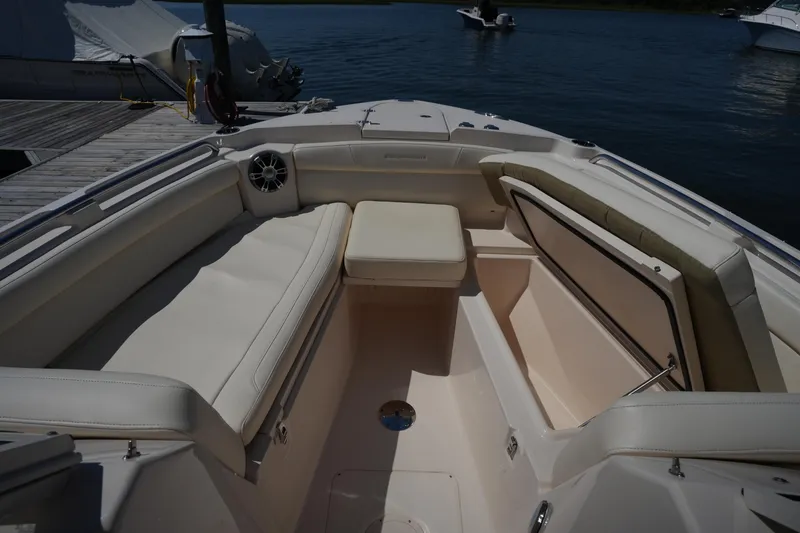 Slide: The Image of 2023 Grady-White Freedom 285 boat interior with cushioned seating and storage compartments. - 45