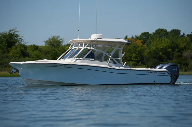 Slide: The Image of 2023 Grady-White Freedom 285 boat cruising on a calm lake. - 6