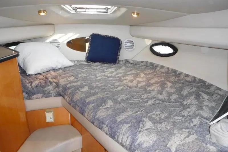 Slide: The Image of 2001 Regal Commodore 2960 cabin interior with bed, pillows, and porthole windows. - 15