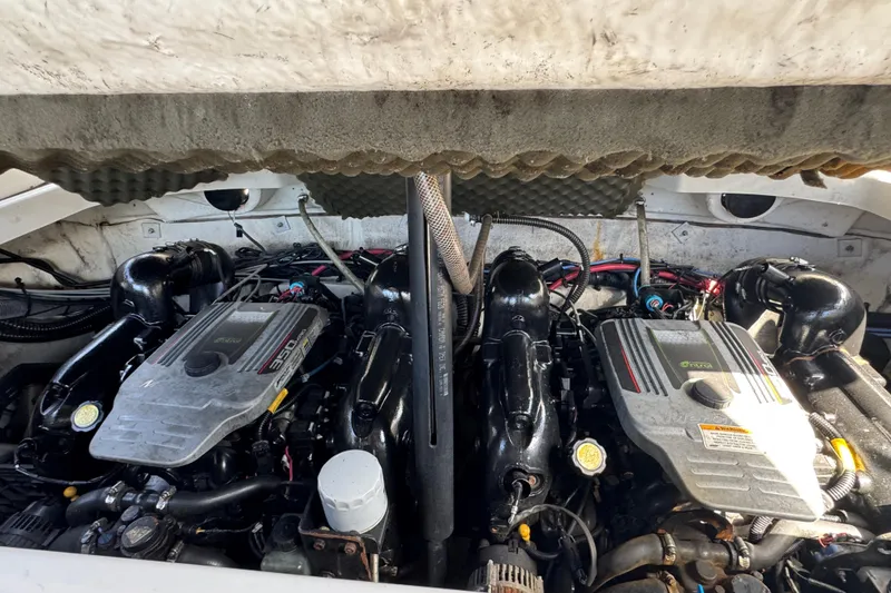 Slide: The Image of Engine compartment of a 2012 Crownline 305 SS boat, featuring dual engines. - 10