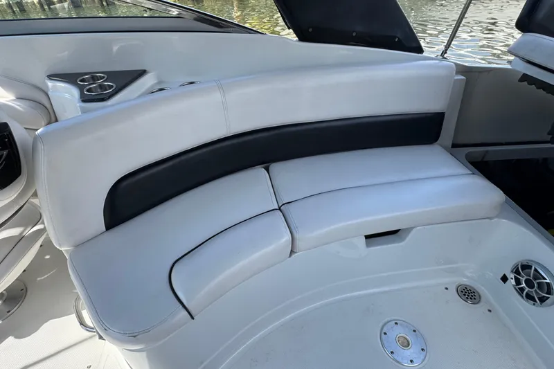 Slide: The Image of 2012 Crownline 305 SS boat interior with white seating and cup holders. - 11