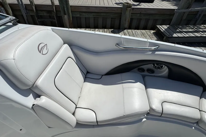 Slide: The Image of 2012 Crownline 305 SS boat interior with white leather seating and cup holders. - 15