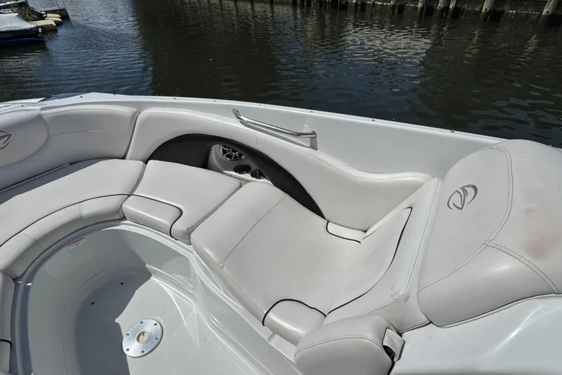 Slide: The Image of Luxurious seating on a 2012 Crownline 305 SS boat, docked by the water. - 16