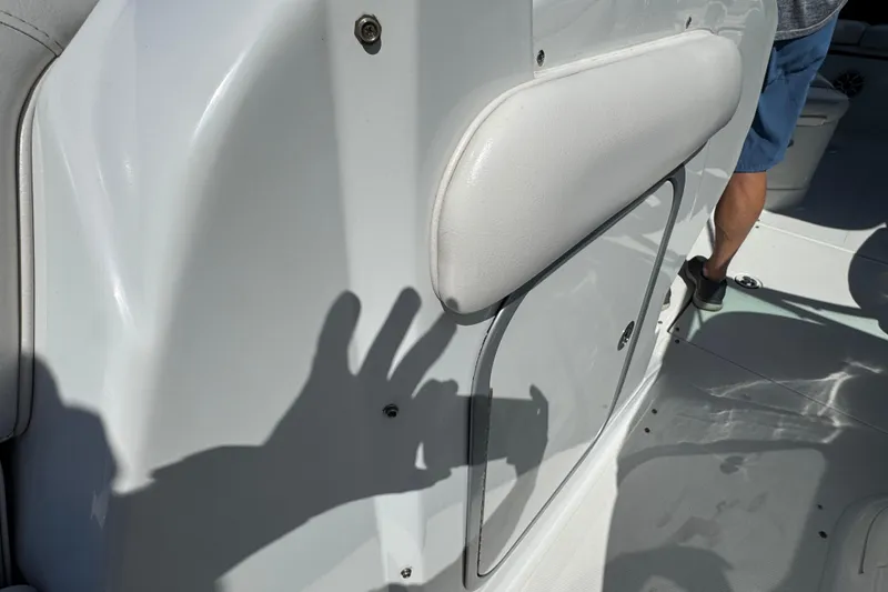 Slide: The Image of Interior view of a 2012 Crownline 305 SS boat, featuring white seating and shadow play. - 19