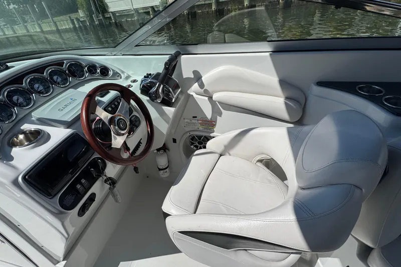 Slide: The Image of 2012 Crownline 305 SS boat cockpit with steering wheel and control panel. - 20