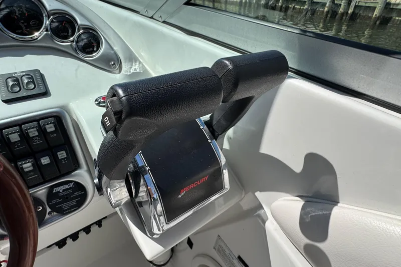 Slide: The Image of Throttle controls on a 2012 Crownline 305 SS boat dashboard. - 25