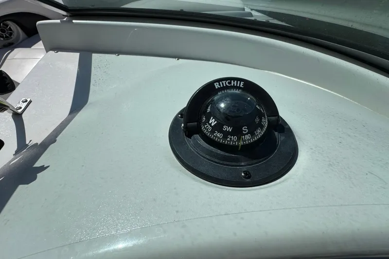 Slide: The Image of Compass on 2012 Crownline 305 SS boat dashboard under sunlight. - 26