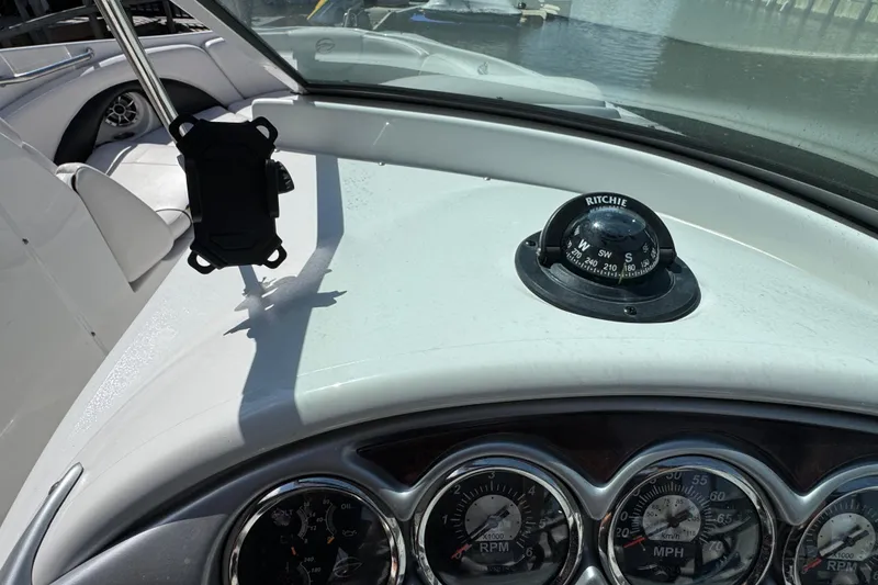 Slide: The Image of Dashboard of 2012 Crownline 305 SS boat with compass and gauges. - 27