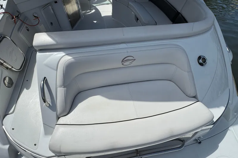 Slide: The Image of 2012 Crownline 305 SS boat interior with white seating and sleek design. - 3