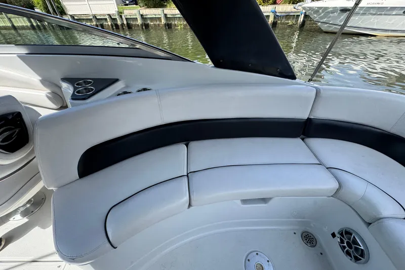 Slide: The Image of Luxurious seating on 2012 Crownline 305 SS boat, featuring sleek white and black upholstery. - 6