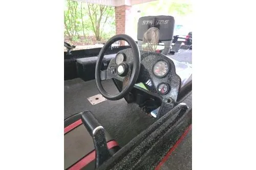 Slide: The Image of 1992 Stratos Mod V 264FS boat interior with steering wheel and dashboard controls. - 3
