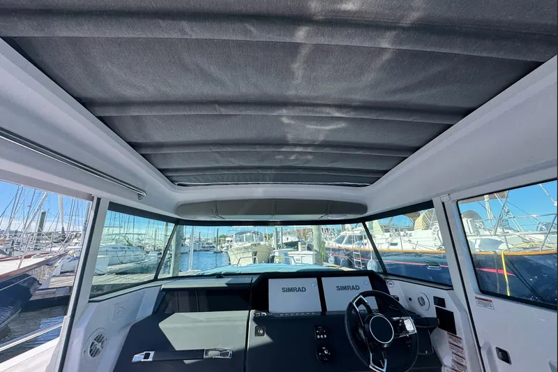 Slide: The Image of 2024 Axopar 37 XC CROSS CABIN interior with panoramic windows and modern dashboard. - 10