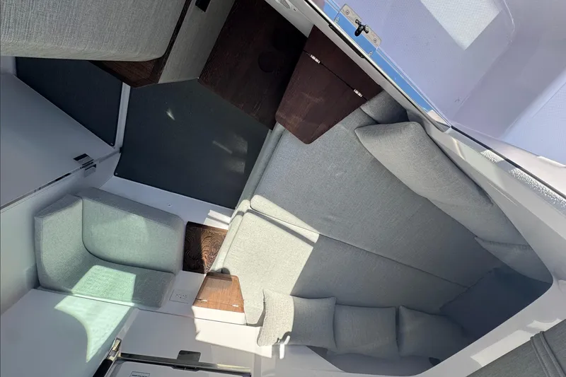 Slide: The Image of 2024 Axopar 37 XC CROSS CABIN interior with modern seating and wooden accents. - 19