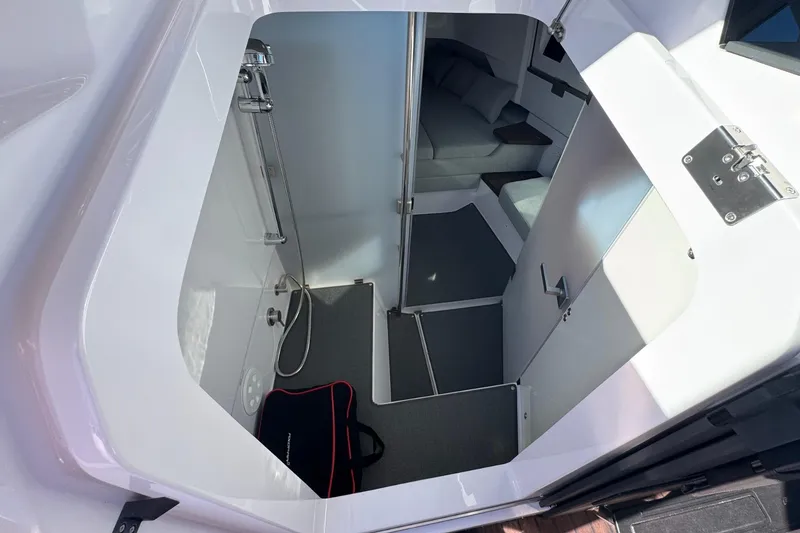 Slide: The Image of 2024 Axopar 37 XC CROSS CABIN interior with modern shower and seating area. - 20