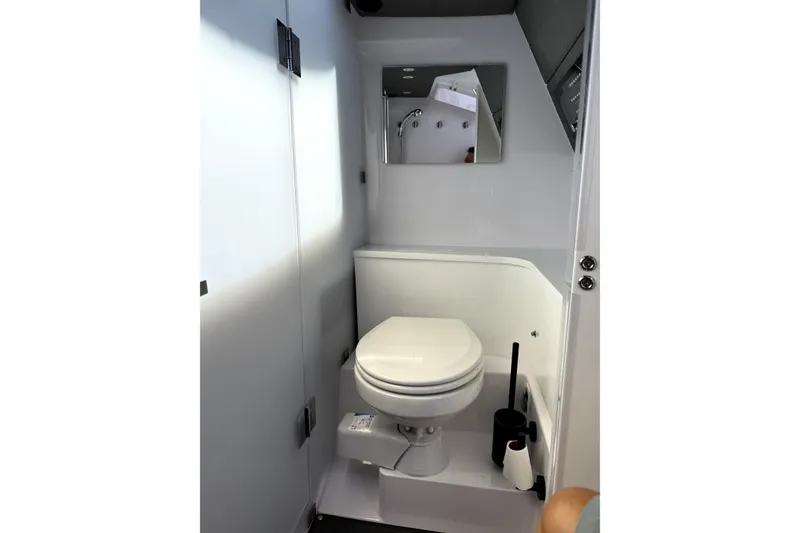 Slide: The Image of 2024 Axopar 37 XC CROSS CABIN bathroom with toilet and mirror. - 23