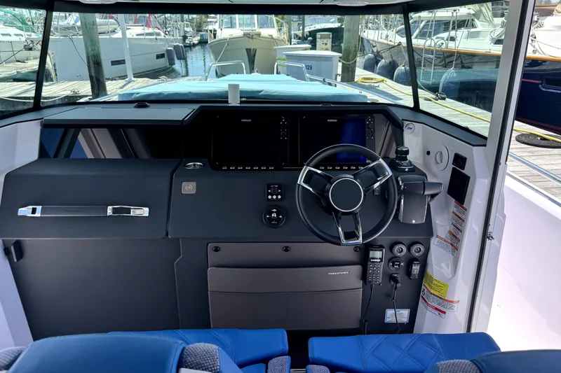 Slide: The Image of 2024 Axopar 37 XC CROSS CABIN helm with modern controls and navigation system. - 8