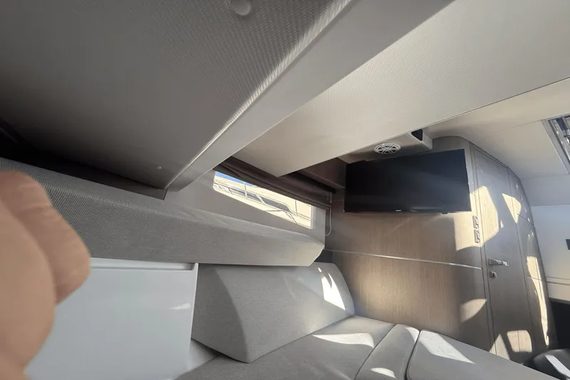 Slide: The Image of Interior of 2024 Galeon 325 GTO with cozy bed and pillows. - 34