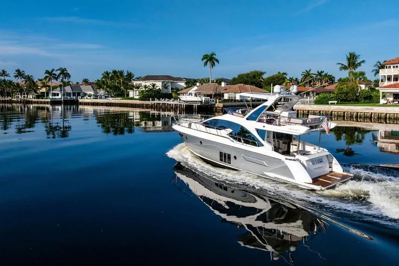 Slide: The Image of Luxurious 2015 Azimut Fly 50 yacht cruising in a serene waterfront setting. - 10
