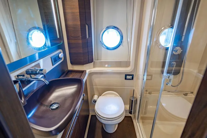 Slide: The Image of Luxurious bathroom in 2015 Azimut Fly 50 yacht with modern fixtures and porthole window. - 113