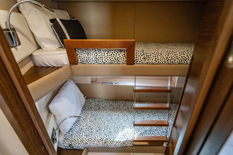 Slide: The Image of Bunk beds in 2015 Azimut Fly 50 yacht cabin with patterned bedding and wooden accents. - 121