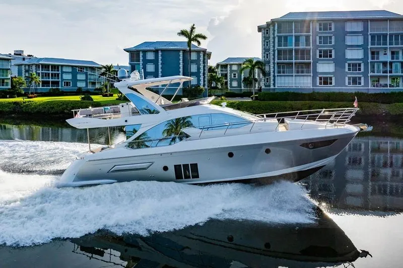 Slide: The Image of Luxury 2015 Azimut Fly 50 yacht cruising near waterfront buildings. - 14