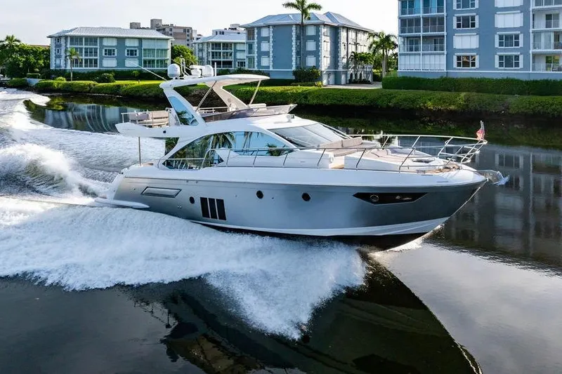 Slide: The Image of Luxury Azimut Fly 50 yacht cruising near waterfront buildings, 2015 model. - 15