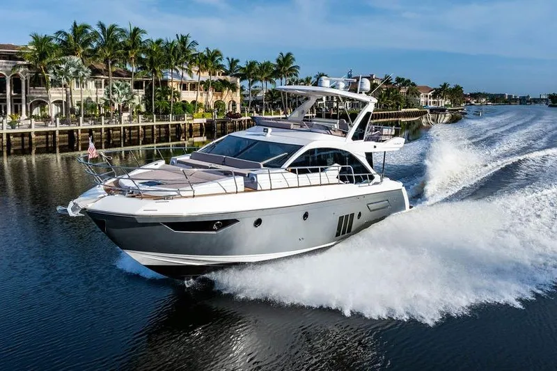 Slide: The Image of 2015 Azimut Fly 50 yacht cruising on a scenic waterway with palm trees. - 21