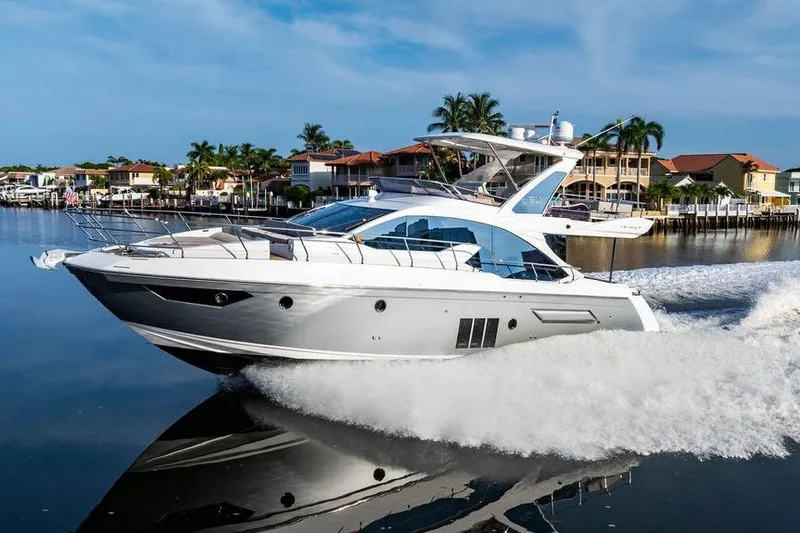 Slide: The Image of 2015 Azimut Fly 50 yacht cruising on a calm, scenic waterway. - 27