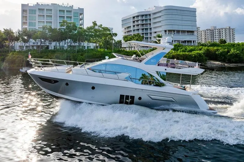 Slide: The Image of Luxury Azimut Fly 50 yacht cruising near modern waterfront buildings, 2015 model. - 29