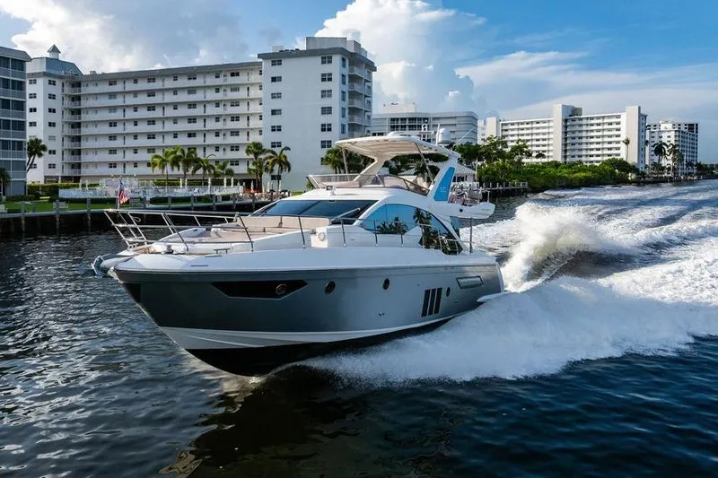 Slide: The Image of Azimut Fly 50 yacht cruising near waterfront buildings, 2015 model. - 31