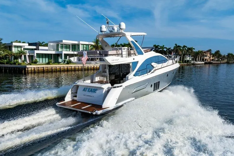 Slide: The Image of 2015 Azimut Fly 50 yacht cruising near luxury waterfront homes. - 33