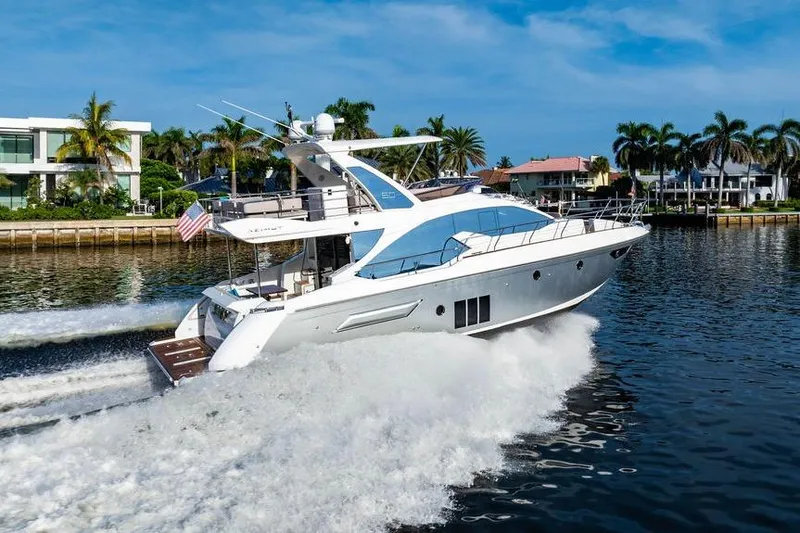 Slide: The Image of 2015 Azimut Fly 50 yacht cruising on a sunny day near waterfront homes. - 34